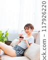 Woman in loungewear relaxing on sofa / Holiday morning / Relaxing 117926220
