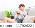 Woman in loungewear relaxing on sofa / Holiday morning / Relaxing 117926221