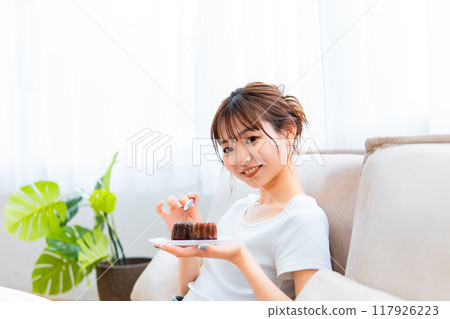 Woman in loungewear relaxing on sofa / Holiday morning / Relaxing 117926223