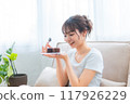 Woman in loungewear relaxing on sofa / Holiday morning / Relaxing 117926229