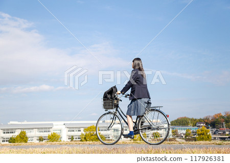 High school girl cycling to school High school girl cycling to school 117926381