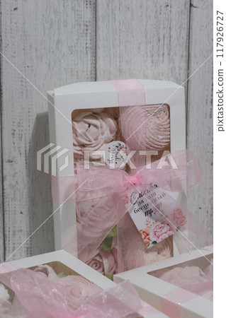 Three boxes of homemade marshmallows. Tied with a ribbon. The tags have the inscription in Russian Thank you for your invaluable work  Flowers made of marshmallow. Close up. 117926727