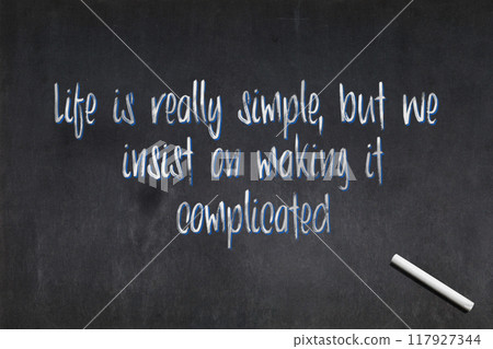 Life is really simple, but we insist on making it complicated - Confucius quote on a blackboard Life is really simple, but we insist on making it complicated - Confucius quote on a blackboard 117927344