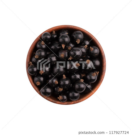 black currant in wooden bowl isolated on white 117927724