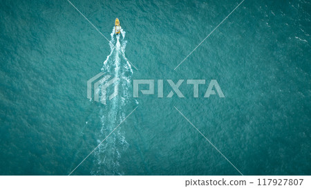 Jet boat sailing in sunset sea 117927807