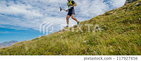 athlete with trekking poles in hand running steep descent in mountain marathon athlete with trekking poles in hand running steep descent in mountain marathon 117927856