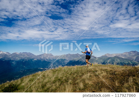 man with trekking poles in hand running mountain marathon man with trekking poles in hand running mountain marathon 117927860