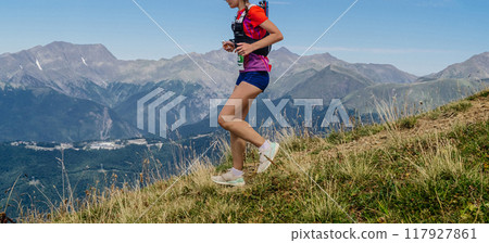 female athlete with camelbak running steep downhill mountain marathon female athlete with camelbak running steep downhill mountain marathon 117927861