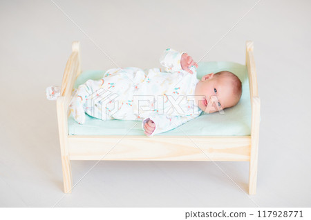 Little baby on toy bed Little baby on toy bed 117928771