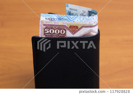 Kazakhstani tenge in the black wallet 117928828