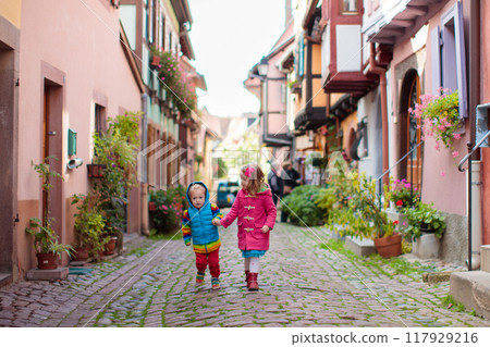 Kids walking down a street in historical medieval city center Kids walking down a street in historical medieval city center 117929216