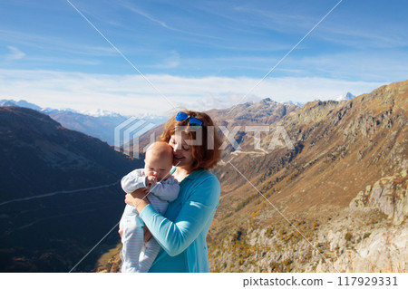 Family with kids hiking in the mountains 117929331