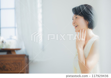 Middle-aged woman doing skin care 117929436