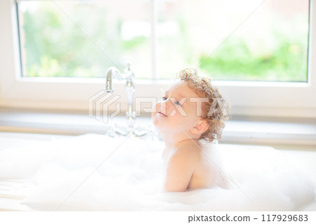 Baby taking bath in kitchen sink Baby taking bath in kitchen sink 117929683