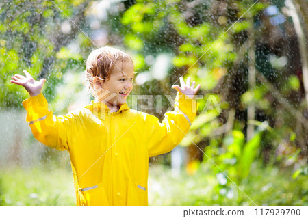 Child playing in the rain. Kid with umbrella. Child playing in the rain. Kid with umbrella. 117929700