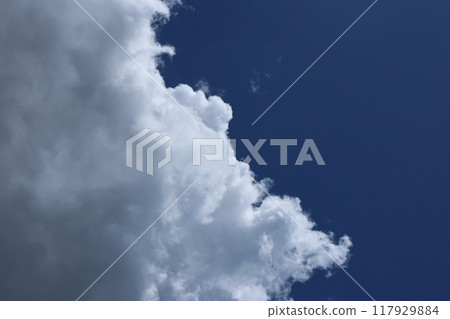 Clouds rising in the blue summer sky Clouds rising in the blue summer sky 117929884