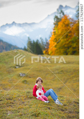 Family with kids hiking in the mountains 117929907