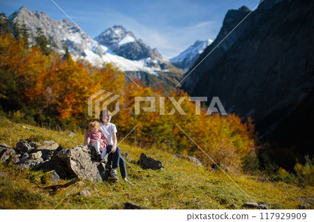 Family with kids hiking in the mountains 117929909