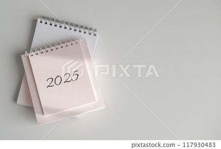 Top view of calendar 2025 on white background 117930483