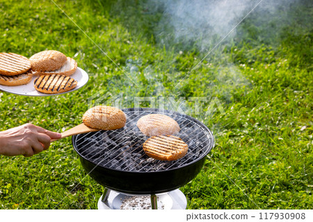 burger bread bun grilling on charcoal grill 117930908