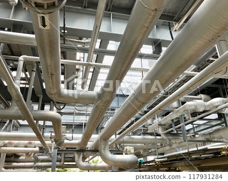 Overhead equipment piping. Piping throughout the factory. Overhead equipment piping. Piping throughout the factory. 117931284