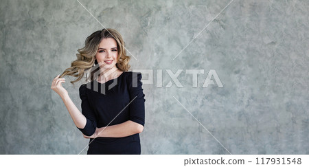 Happy young woman with curly hair and make-up Happy young woman with curly hair and make-up 117931548