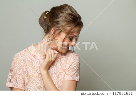 Elegant hairstyle of a young woman in a lace dress. Elegant hairstyle of a young woman in a lace dress. 117931631