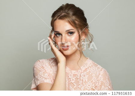 Perfect female model with healthy skin, natural makeup and perfect updo hairstyle Perfect female model with healthy skin, natural makeup and perfect updo hairstyle 117931633
