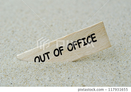 Out Of Office text on wooden stick with beach sand background. Off work concept 117931655