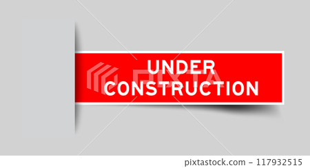 Red color square label sticker with word under construction that inserted in gray background 117932515