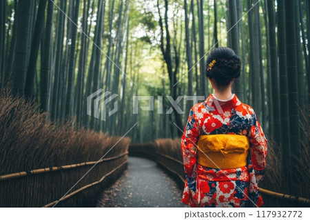 Woman wearing traditional kimono walking through bamboo forest in japan 117932772