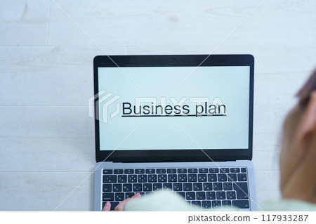 A young woman creating documents on a computer 117933287