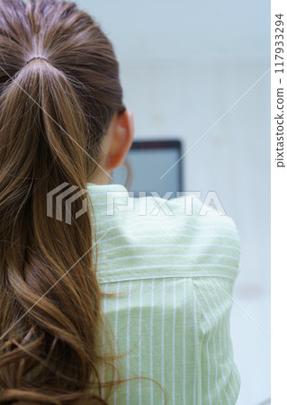 A young woman creating documents on a computer A young woman creating documents on a computer 117933294