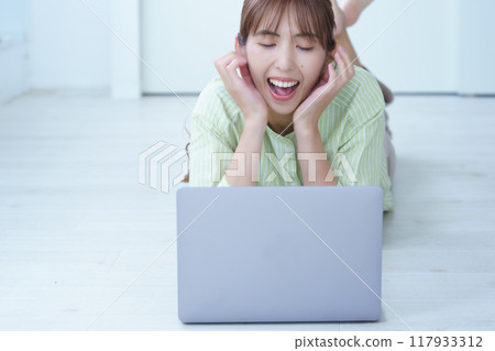 A young woman creating documents on a computer 117933312