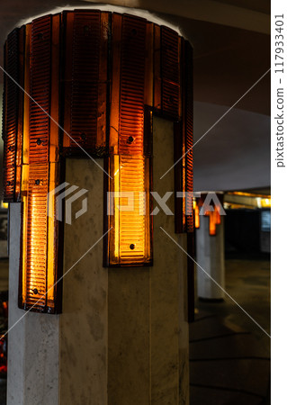 Lighting of columns in the underpass. Orange lighting. Decorative lighting Lighting of columns in the underpass. Orange lighting. Decorative lighting 117933401