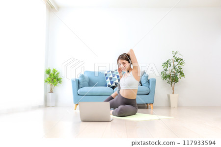 Young women delivering yoga lessons online 117933594