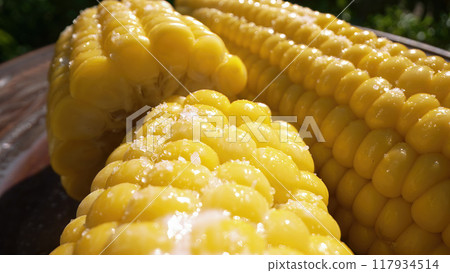 Freshly boiled tasty sweet golden corn cob. Appetizing healthy natural nutrition 117934514