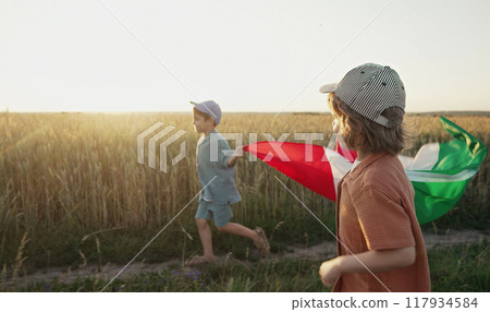 Italian little kids - patriot. football fans children runs with national flag on nature background 117934584