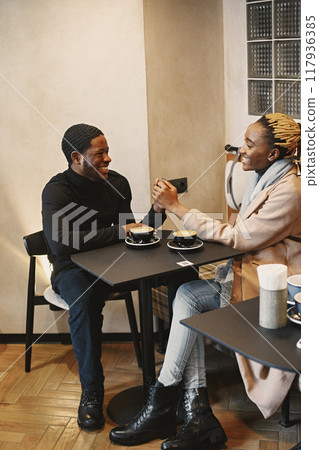 Two young people in cafe. African couple enjoying the time spending with each other. 117936385