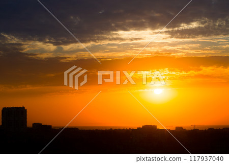 Sun in the Clouds over the Roofs of a Seaside Town Sun in the Clouds over the Roofs of a Seaside Town 117937040