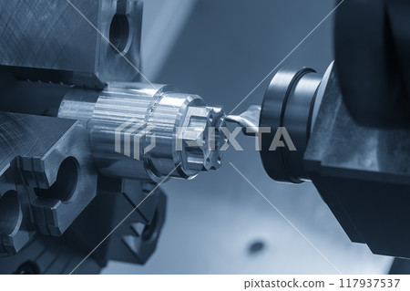 The CNC turn-mill machine chamfer milling the metal shaft parts. 117937537