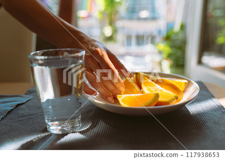 peeled oranges and glass water on table 117938653