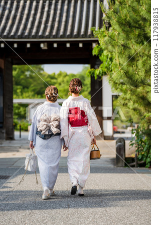 Two women in kimonos walking through the temple grounds Two women in kimonos walking through the temple grounds 117938815
