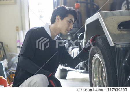 Man inspecting a truck Man inspecting a truck 117939265
