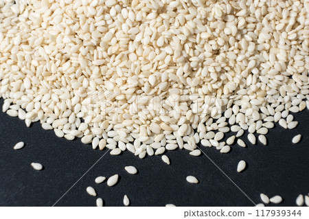 Macro kernels of white roasted sesame seeds. Macro kernels of white roasted sesame seeds. 117939344