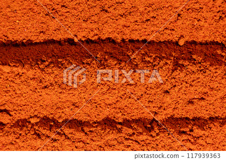 Abstract terracotta striped background of scattered paprika Abstract terracotta striped background of scattered paprika 117939363