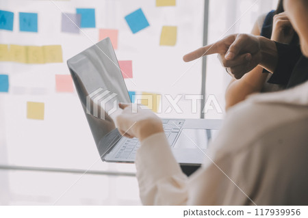 Financial analysts analyze business financial reports on a digital tablet planning investment project during a discussion at a meeting of corporate showing the results of their successful teamwork. 117939956