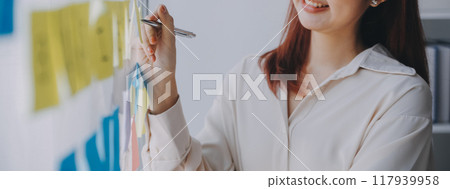 Financial analysts analyze business financial reports on a digital tablet planning investment project during a discussion at a meeting of corporate showing the results of their successful teamwork. 117939958
