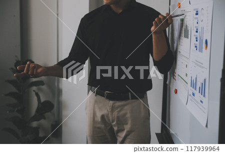 Financial analysts analyze business financial reports on a digital tablet planning investment project during a discussion at a meeting of corporate showing the results of their successful teamwork. 117939964