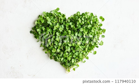 Heart-shaped microgreens on white background. Love for nature, healthy eating. 117940110